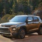 A brown 2021 Chevy Trailblazer is driving on a dirt road after leaving a Chevy dealership in Bethlehem, PA.