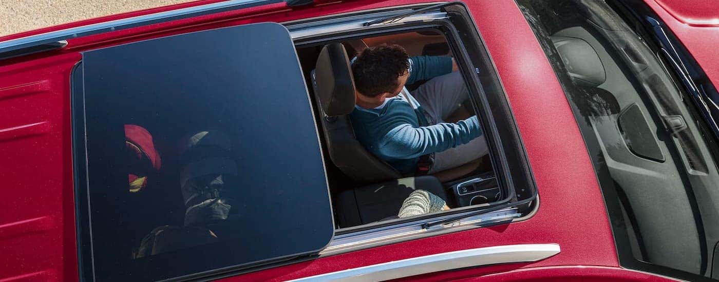 A view from above shows an open sunroof on a red 2020 Chevy Equinox.