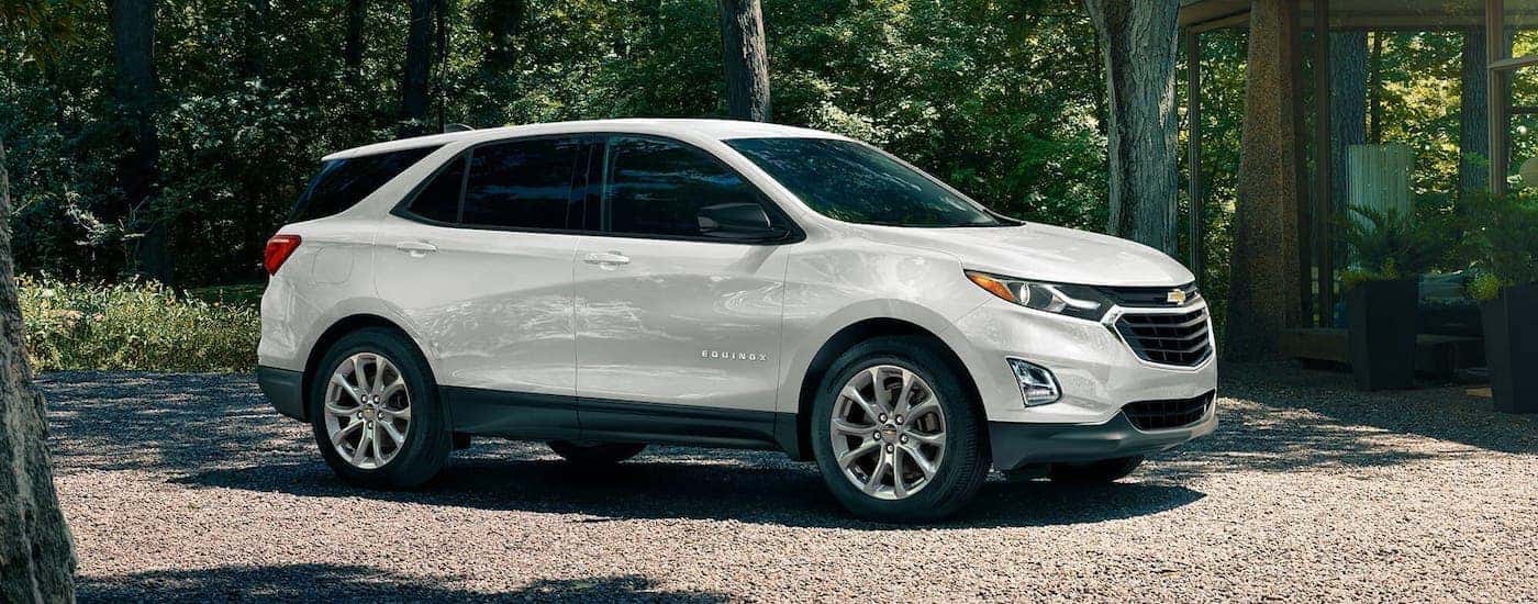 A white 2020 Chevy Equinox is parked in front of a woodland home near Bethlehem, PA, after winning the 2020 Chevy Equinox vs 2020 Nissan Rogue comparison.
