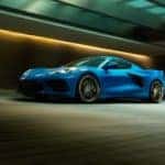 A blue 2021 Chevy Corvette Stingray is driving through a tunnel.