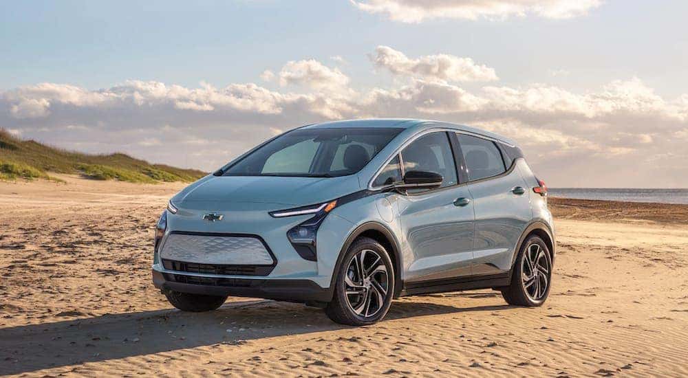 A light blue 2022 Chevy Bolt EV is parked on the beach after leaving the Pennsylvania electric car dealer.
