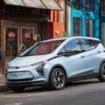 A baby blue 2022 Chevy Bolt EV is parked on a city street after leaving a Pennsylvania electric car dealer.