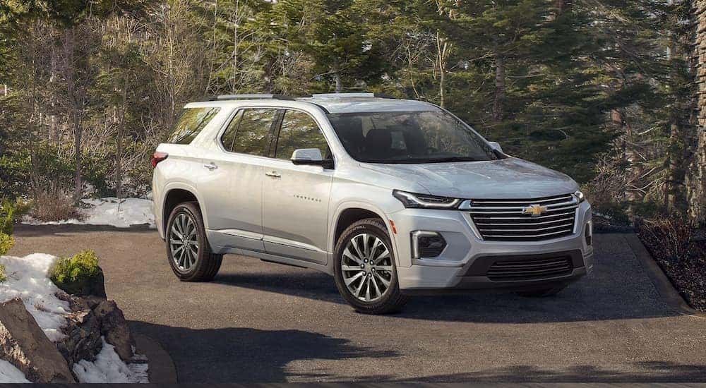 A silver 2022 Chevy Traverse is shown parked in a driveway after making Chevy lease deals.