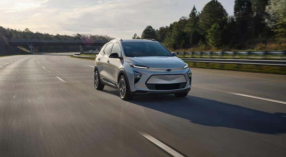 A silver 2022 Bolt EUV is shown driving on an open highway.