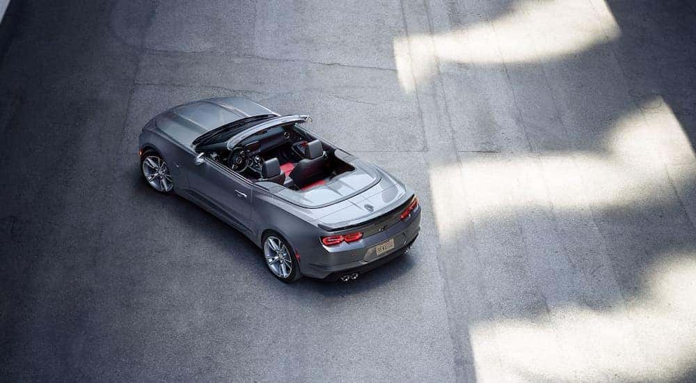 A grey 2023 Chevy Camaro is shown from a rear angle.