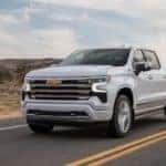 A white 2022 Chevy Silverado 1500 High Country is shown from the front at an angle.