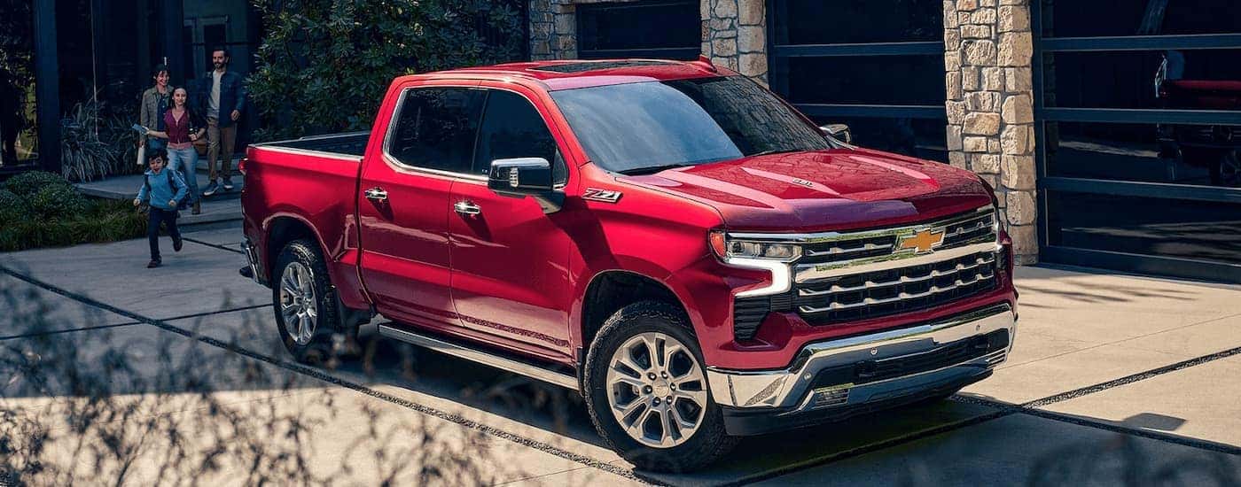 A red 2023 Chevy Silverado 1500 Z71 is shown parked in a driveway.
