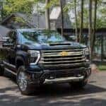 A black 2024 Chevy Silverado 2500 HD High Country is shown from the front at an angle after leaving a dealer that had a Chevy Silverado for sale near Allentown, PA..