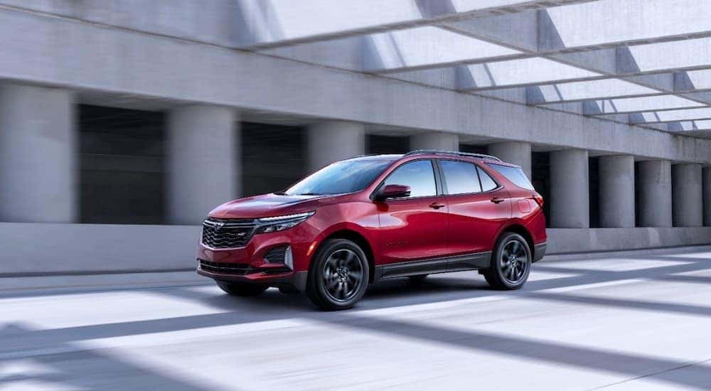A red 2023 Chevy Equinox RS is shown from the side.