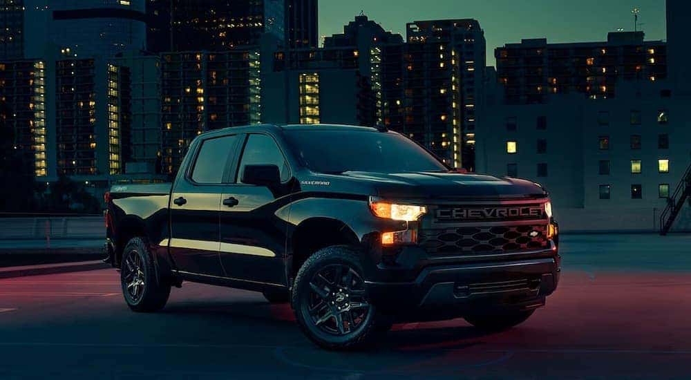 A black 2023 Chevy Silverado 1500 Custom is shown from the front at an angle.
