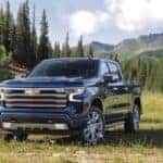 A blue 2024 Chevy Silverado 1500 High Country is shown from the front at an angle.