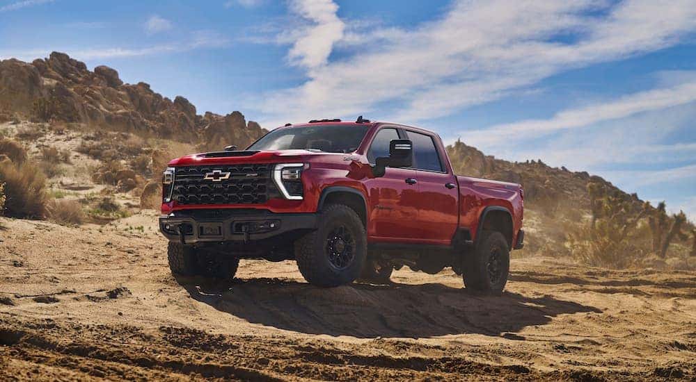 A red 2024 Chevy Silverado 2500 HD ZR2 Bison is shown from the front at angle.