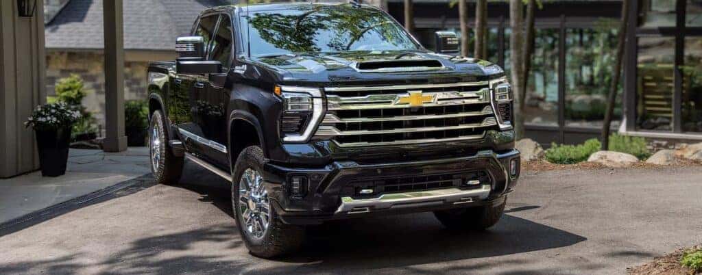 A black 2024 Chevy Silverado 2500HD High for sale near Hellertown, PA is shown parked in a driveway.