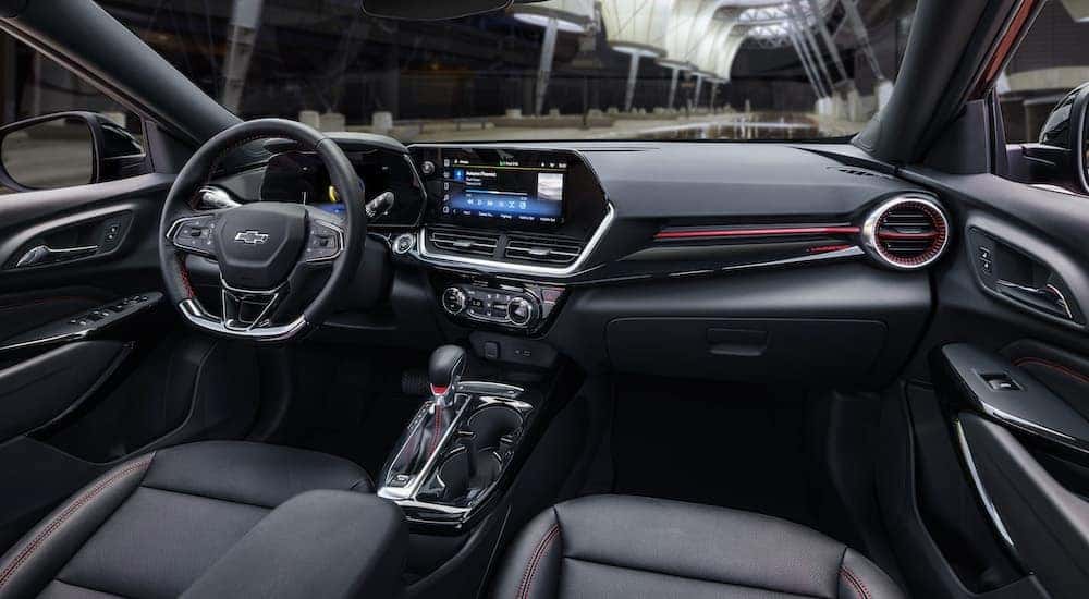 The black interior of a 2024 Chevy Trax RS is shown from the passenger seat.