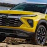 A yellow 2024 Chevy Trailblazer is parked on a beach