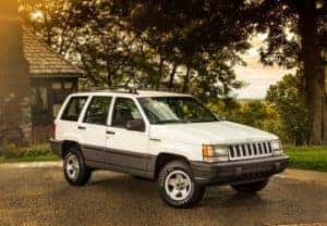 white-jeep-parked-in-driveway