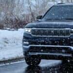 front of grand wagoneer on winter road