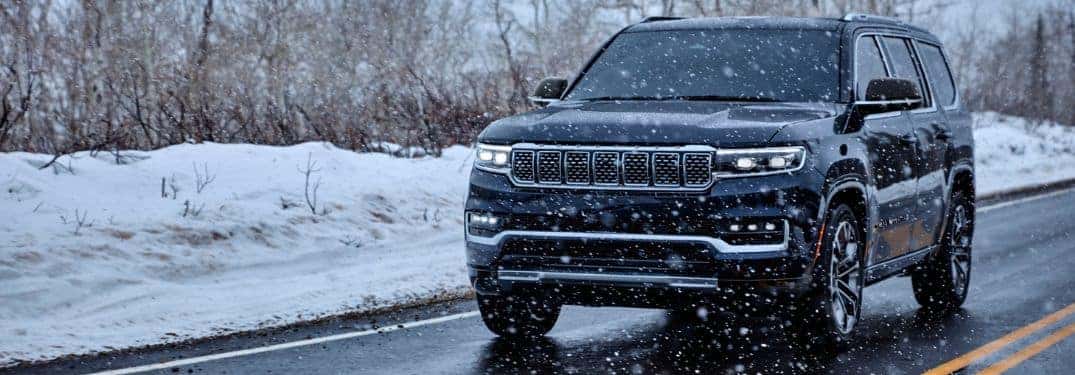front of grand wagoneer on winter road
