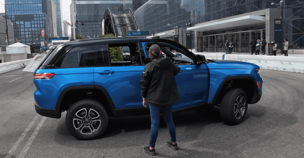 People admiring a Jeep Trailhawk Cherokee at the New York International Auto Show.