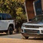 Two 2023 Jeep Wrangler Grand Cherokee 4xe Plugged In to Charge Outside
