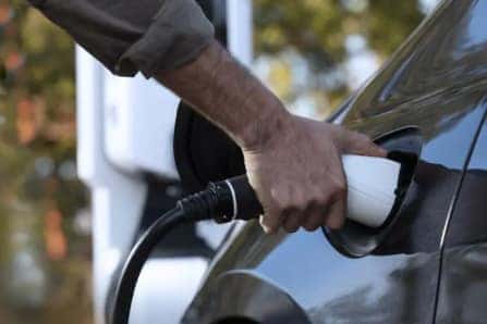 Man Holding Charging Cable to Pacifica Plug-In Hybrid