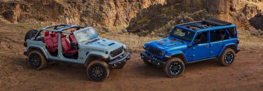Two 2024 Jeep Wrangler Models Parked Front to Front in Rocky Terrain