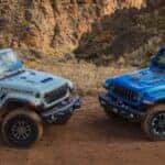 Two 2024 Jeep Wrangler Models Parked Front to Front in Rocky Terrain