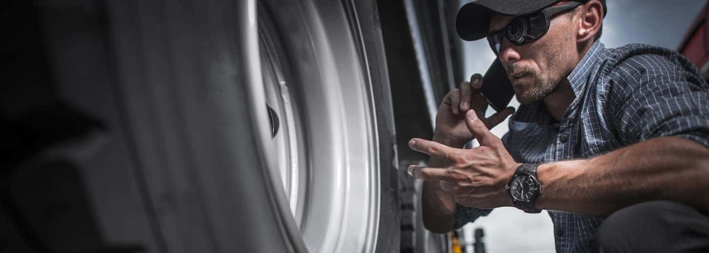 truck mechanic checking tires