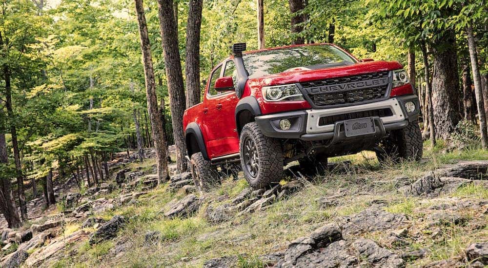 A red 2019 Chevy Colorado fully equipped driving through the woods near Buford, GA.