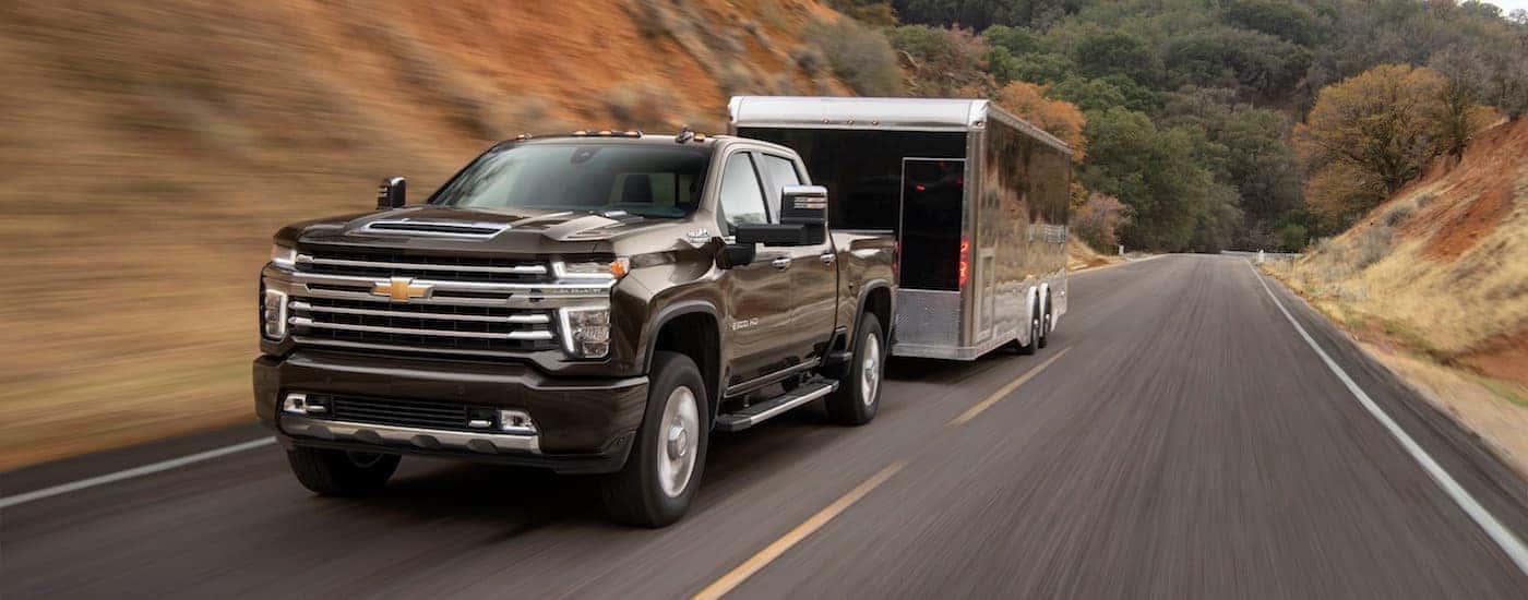 A 2020 Chevy Silverado 2500HD towing a large trailer near Buford, GA. You can find this truck at your local Chevrolet dealer.