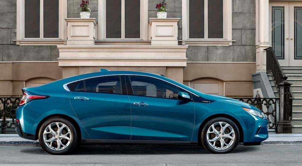 A blue 2019 Chevy Volt is parked outside a city townhouse after leaving an Atlanta Chevy dealer.
