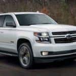 A white 2018 Chevy Tahoe, popular in Atlanta used car dealerships, is driving on a road outside of Buford, GA.
