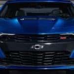 A front end close up of a blue 2019 Chevy Camaro.