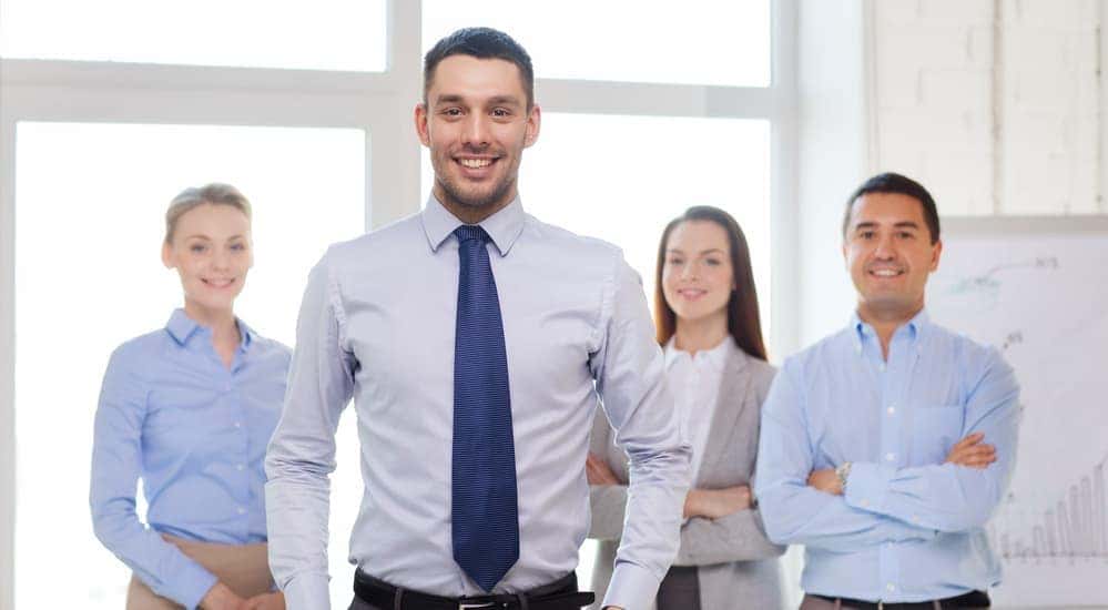 A group of smiling sales staff.