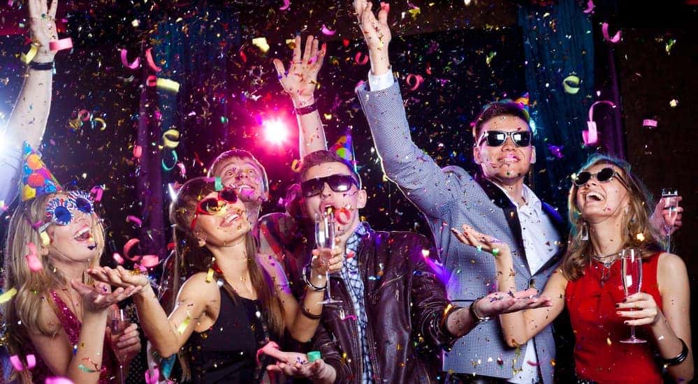 A group of young people are partying at a New Years Eve party.