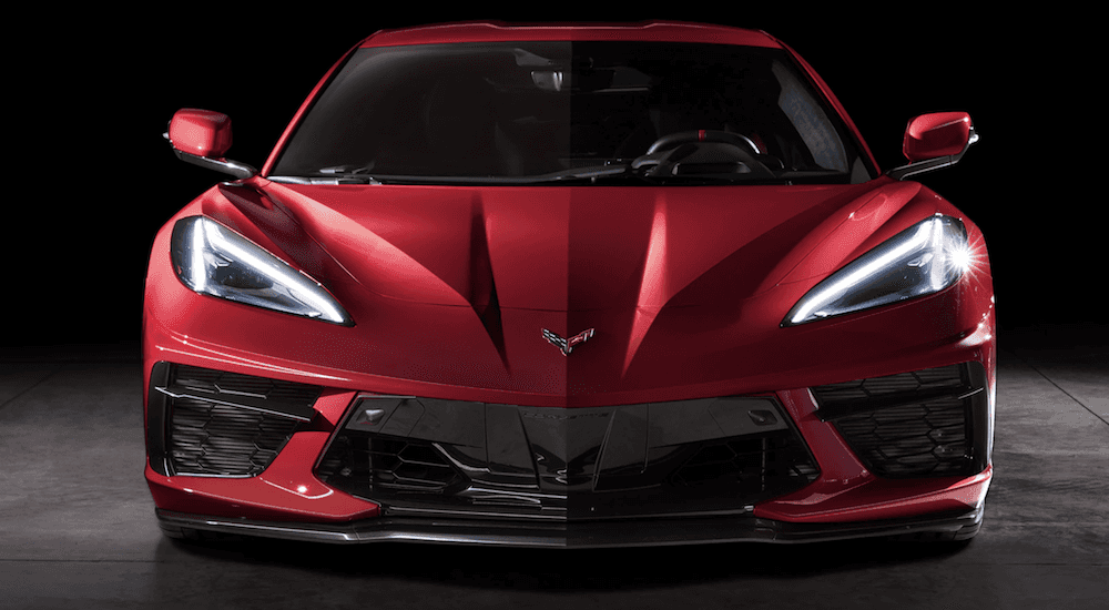 A red 2020 Chevy Corvette is facing front while parked in a dark garage in Buford, GA.