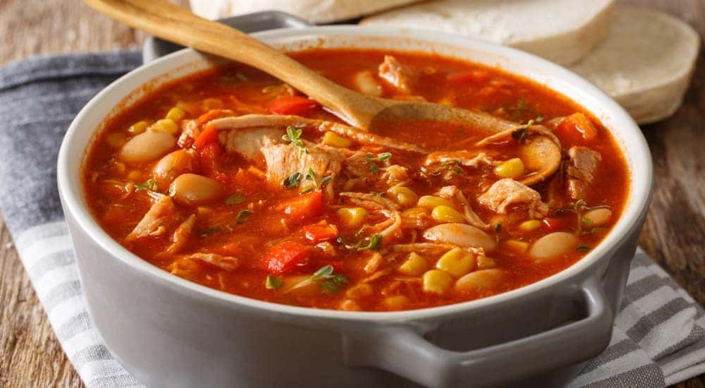 A pot of Brunswick stew is on a table.