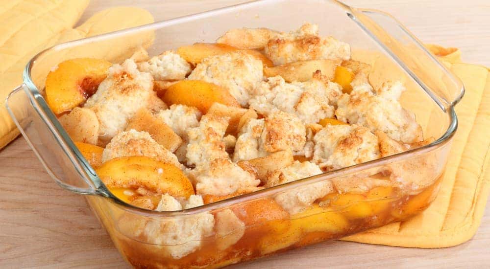 Peach cobbler is in a small glass dish.