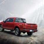 A red 2018 Ford F-150 is parked in a warehouse in Cincinnati, OH, after leaving a used car dealership near me.