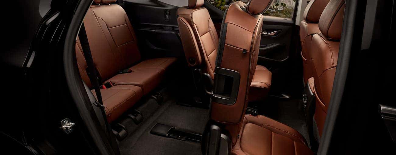 The rear seating in the brown interior of a 2020 Chevy Traverse is shown.