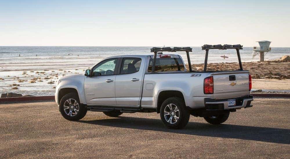 A silver 2017 Chevy Colorado is parked at a beach.