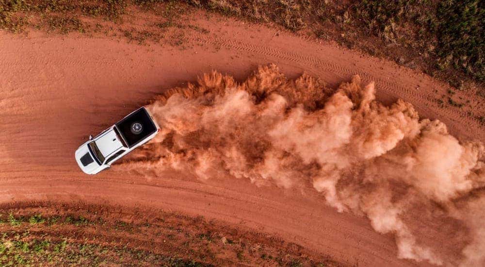 A white 2017 Chevy Colorado ZR2 is shown from above kicking up dirt on a track.