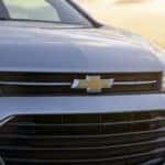 The front of a white 2021 Chevy Trax is shown at sunset.