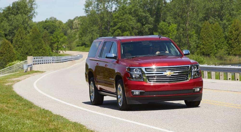 A red 2015 Chevy Suburban is driving on a rural highway outside Buford, GA.