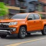 A orange 2021 Chevy Colorado Z71 is driving down the road after visiting an Atlanta Chevy dealer.