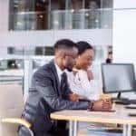 A couple is signing paperwork on a Chevy lease deal.