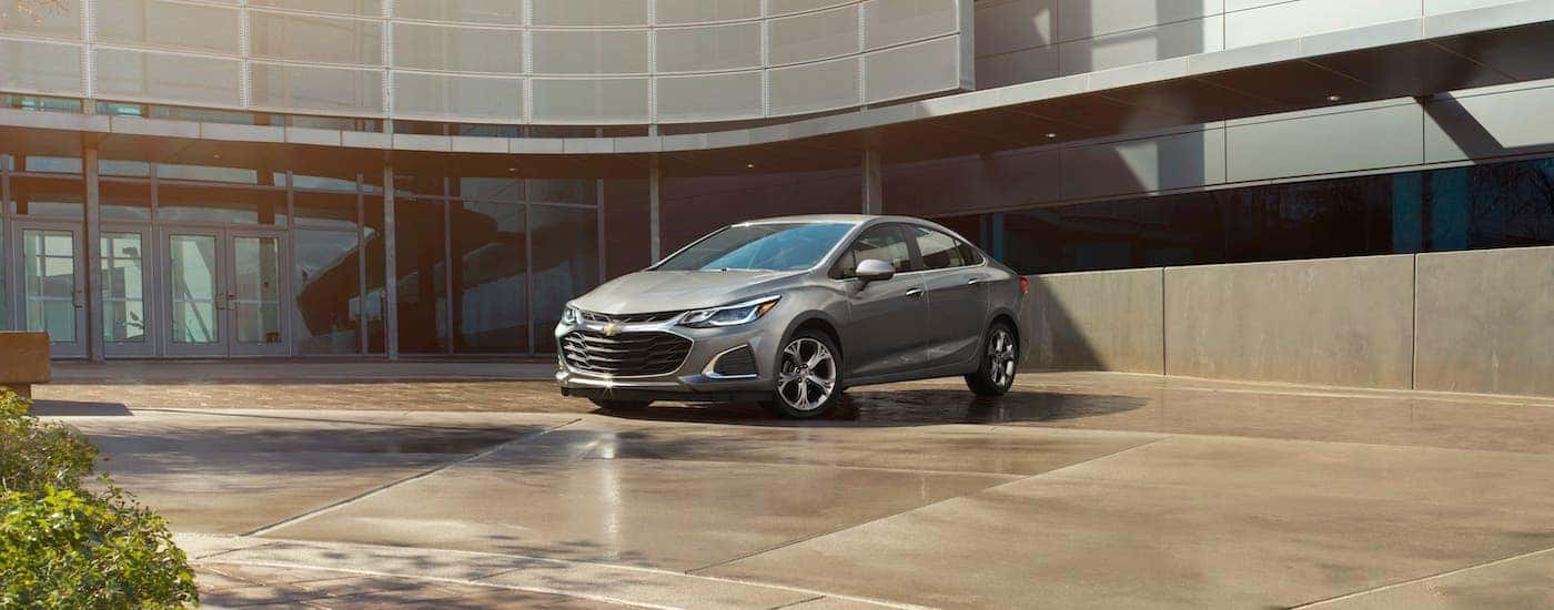 A gray 2019 Chevy Cruze is parked in front of a Chevrolet dealer in Georgia.