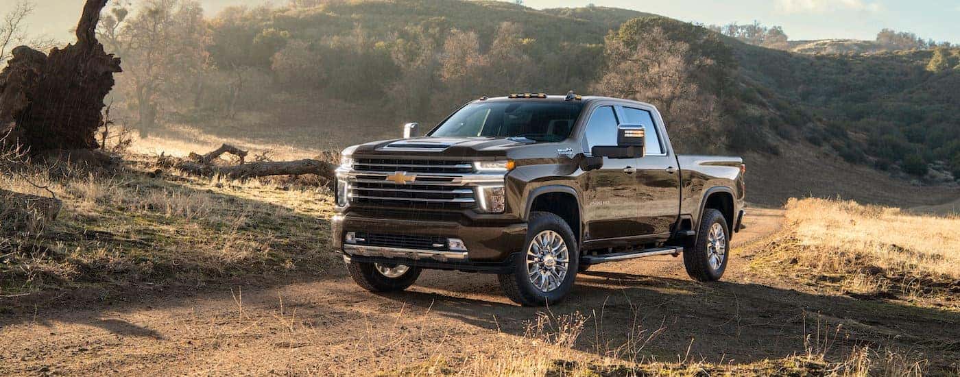 A black 2021 Chevy Silverado 2500 HD High Country is shown from the side after winning the 2021 Chevy Silverado 2500 HD vs 2021 Ram 2500 comparison.