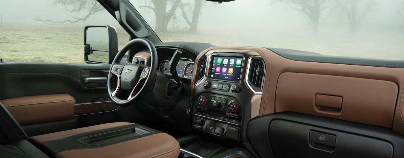 The brown and black interior is shown in a 2021 Chevy Silverado 2500 HD High Country.