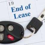 A set of keys are laying on a calendar next to a Chevy end of lease reminder.